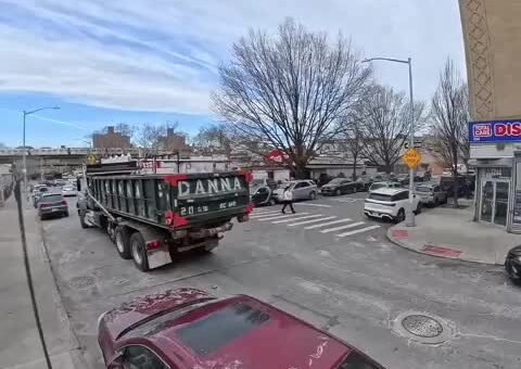 Single operator swapping a commercial dumpster on a narrow street with zero damage