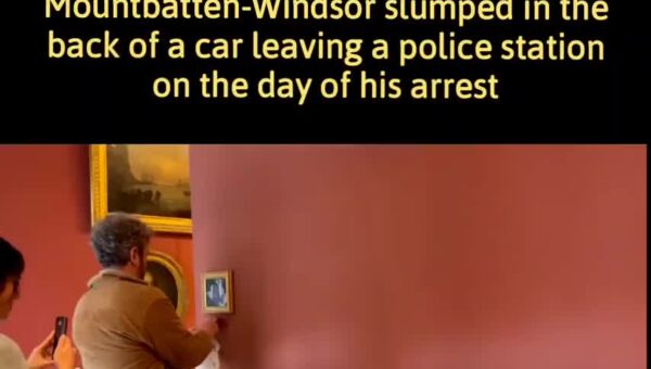 Activists hang a picture of former Prince Andrew, taken after his release from a police…