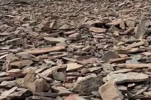 the sound of hail falling on a scree field of slate